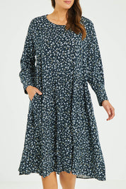 Model Madeline wearing size 10 of the Sharni Dress in colour Floral (Black), from the front, cropped image
