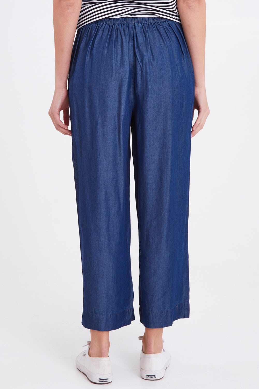Model Madeline wearing size 10 of the Emily Pant in colour Bluehaze (Blue), from the back