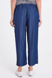 Model Madeline wearing size 10 of the Emily Pant in colour Bluehaze (Blue), from the back