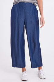 Model Madeline wearing size 10 of the Emily Pant in colour Bluehaze (Blue), from the front, cropped image