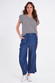 Model Madeline wearing size 10 of the Emily Pant in colour Bluehaze (Blue), from the front, showing the whole outfit