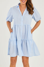 Model Georgia wearing size 10 of the Hayley Dress in colour Blue, from the front, cropped image