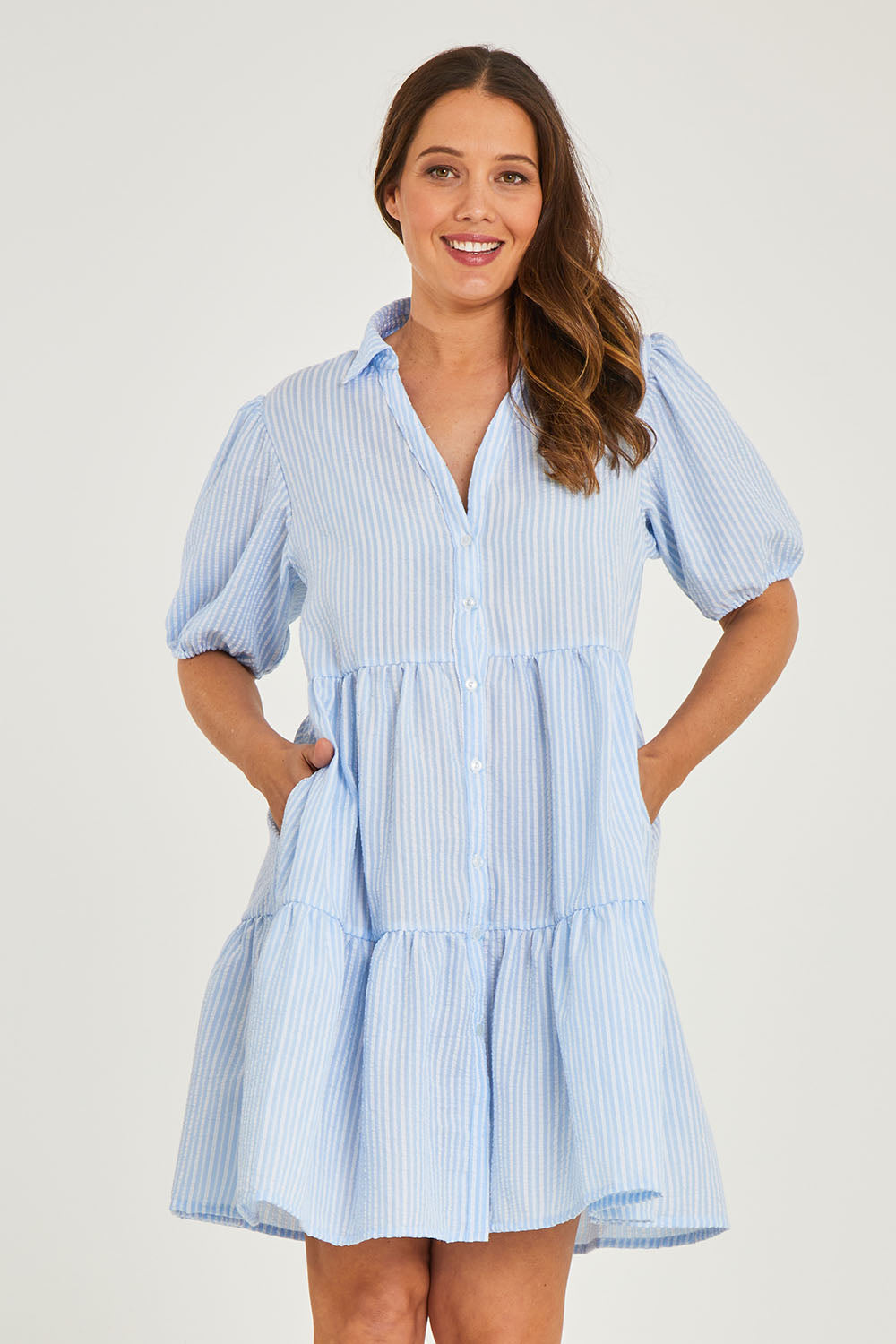 Model Georgia wearing size 10 of the Hayley Dress in colour Blue, from the front, cropped image