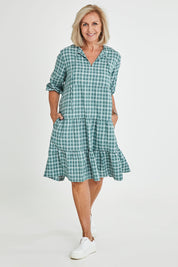 Model Sandy wearing size 10 of the Odette Dress in colour Greenging (Green), from the front, showing the whole outfit