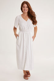 Model Sally wearing size 10 of the Whitney Dress in colour White (White), from the front, showing the whole outfit