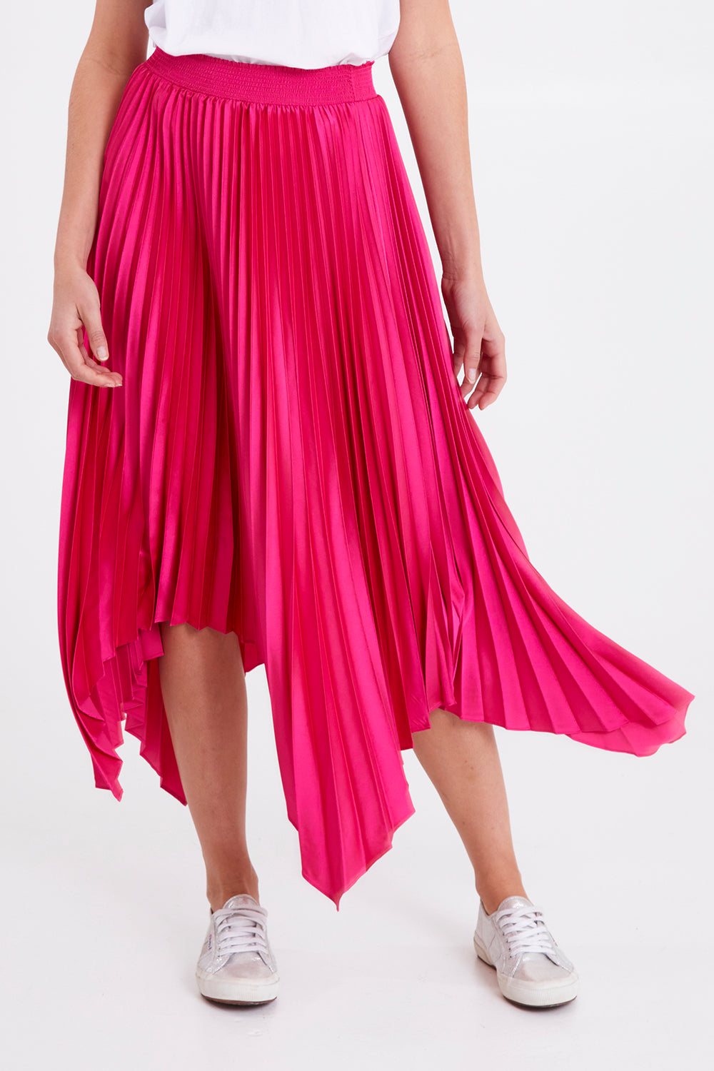 Model Madeline wearing size 10 of the Louis Pleated Skirt in colour Peonypink (Pink), from the front, cropped image