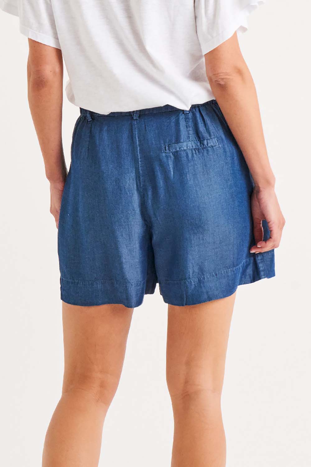 A model wearing the Gabriella Lyocell Short in colour Bluehaze (Blue), from the back
