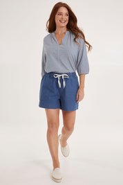 Model Sally wearing size 10 of the Caroline Denim Short in colour Lightwash (Blue), from the front, showing the whole outfit