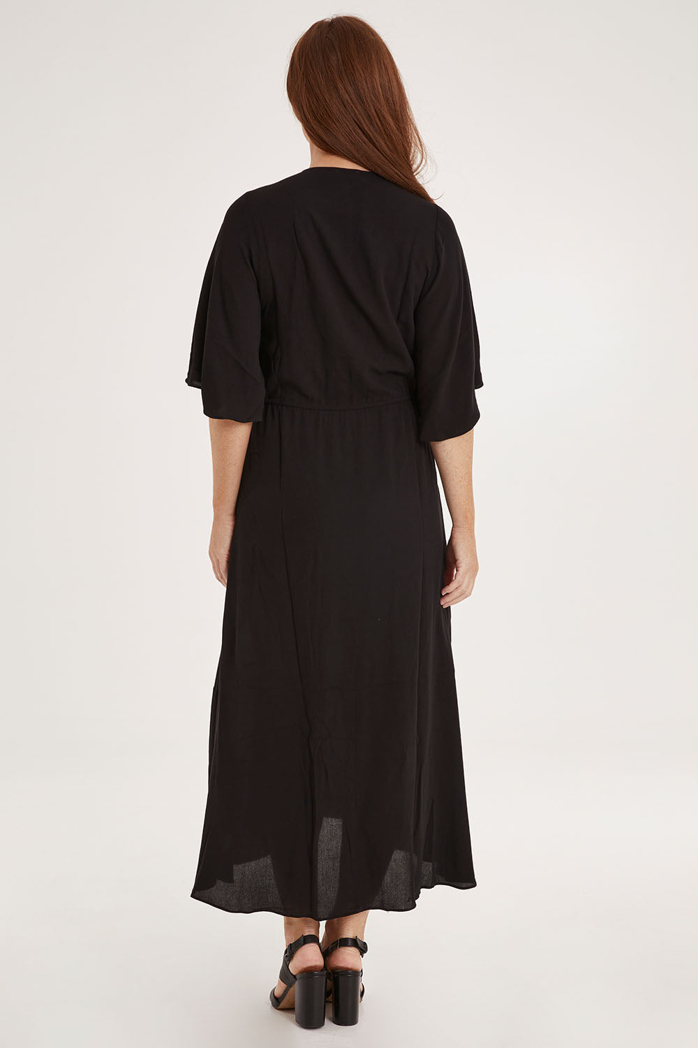 Model Sally wearing size 10 of the Saint Lucia Dress in colour Black (Black), from the back