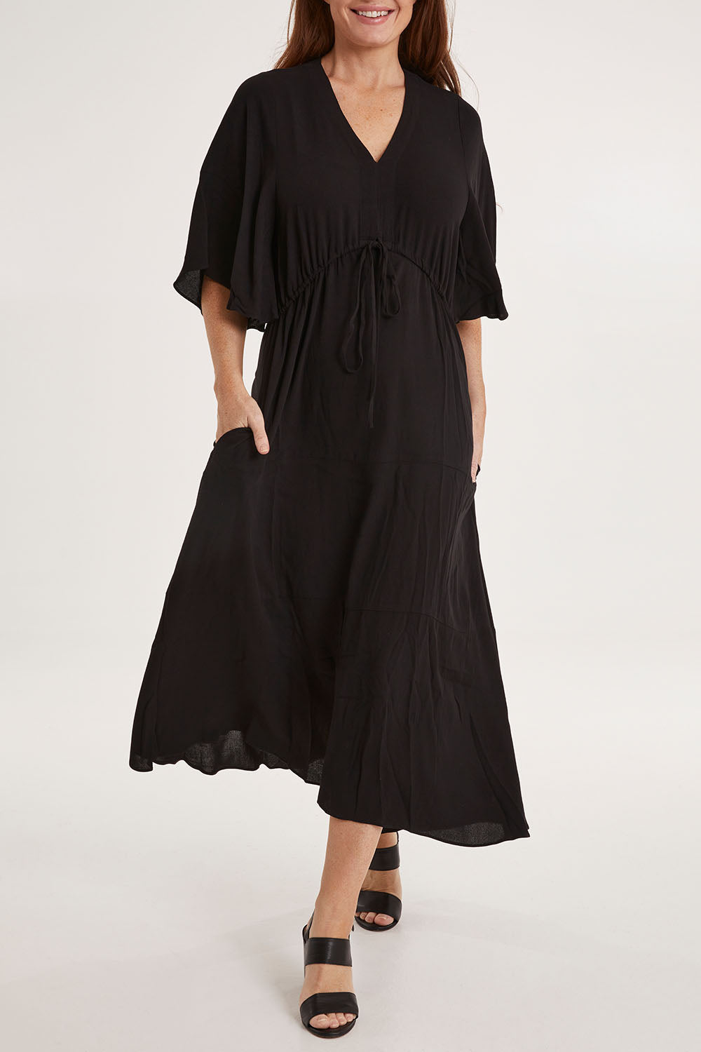 Model Sally wearing size 10 of the Saint Lucia Dress in colour Black (Black), from the front, cropped image