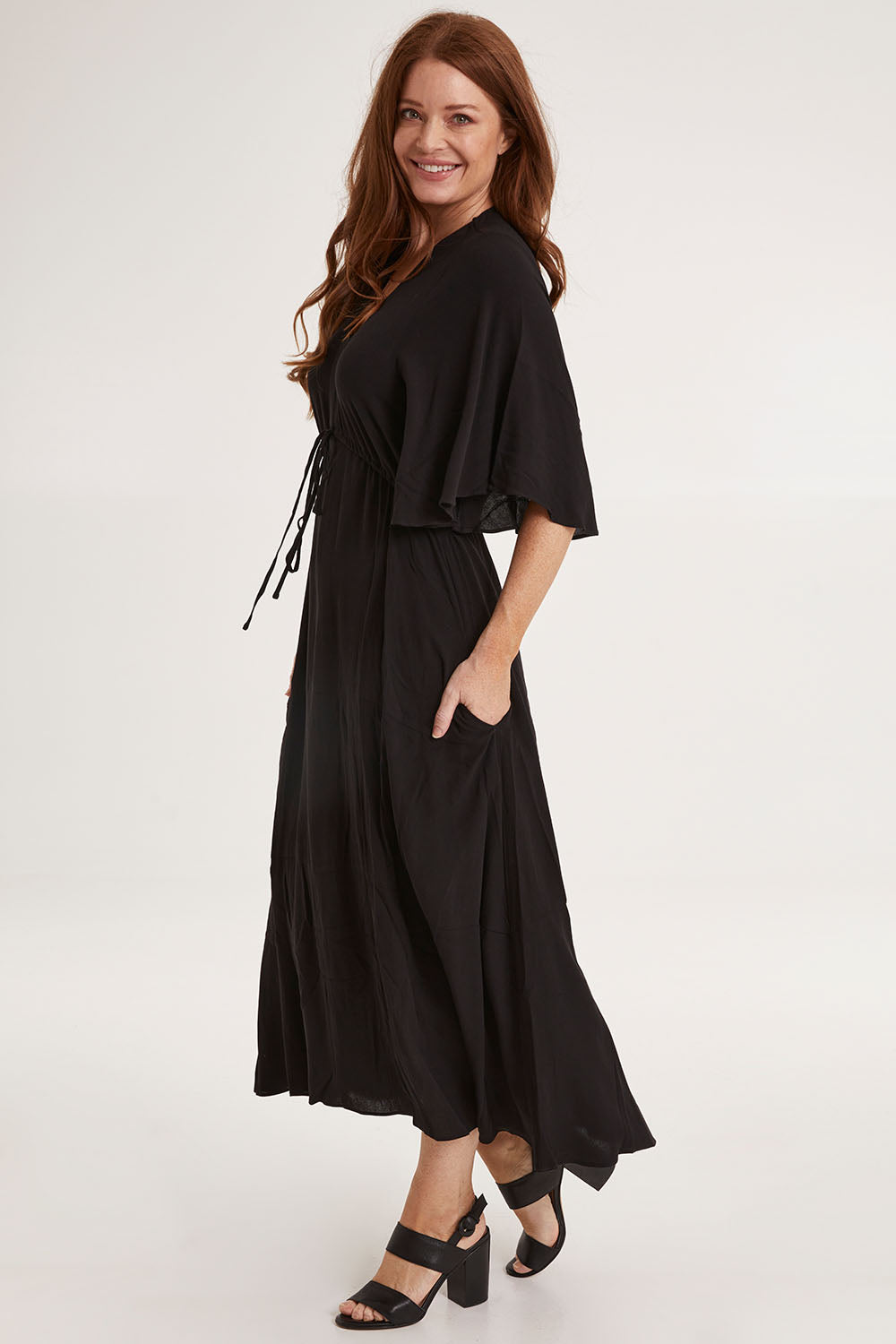 Model Sally wearing size 10 of the Saint Lucia Dress in colour Black (Black), from the front, showing the whole outfit