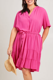 Model Poppy wearing size 16 of the Port Douglas Dress in colour Frenchrose (Pink), from the front, cropped image
