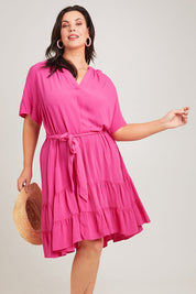 Model Poppy wearing size 16 of the Port Douglas Dress in colour Frenchrose (Pink), from the front, cropped image
