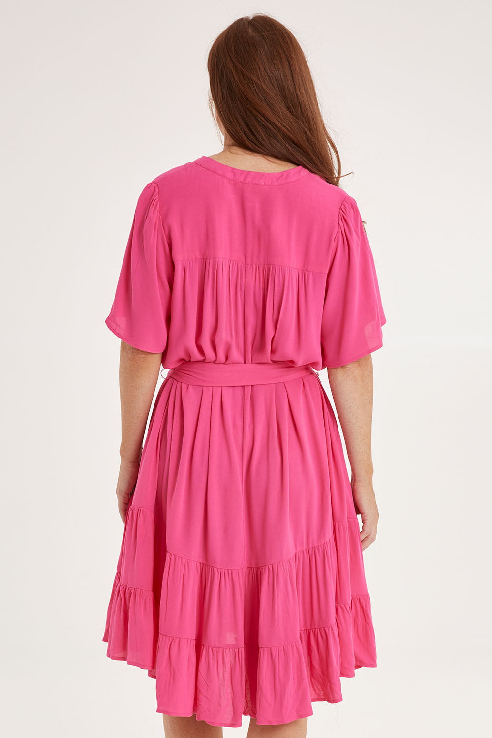 Model Sally wearing size 10 of the Port Douglas Dress in colour Frenchrose (Pink), from the back