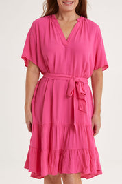 Model Sally wearing size 10 of the Port Douglas Dress in colour Frenchrose (Pink), from the front, cropped image