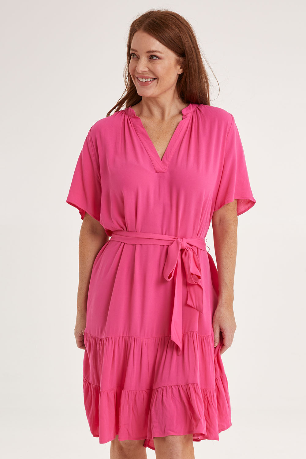 Model Sally wearing size 10 of the Port Douglas Dress in colour Frenchrose (Pink), from the front, cropped image