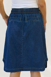 A model wearing the Desiree Cotton Denim Skirt in colour Bluewash (Blue), from the back
