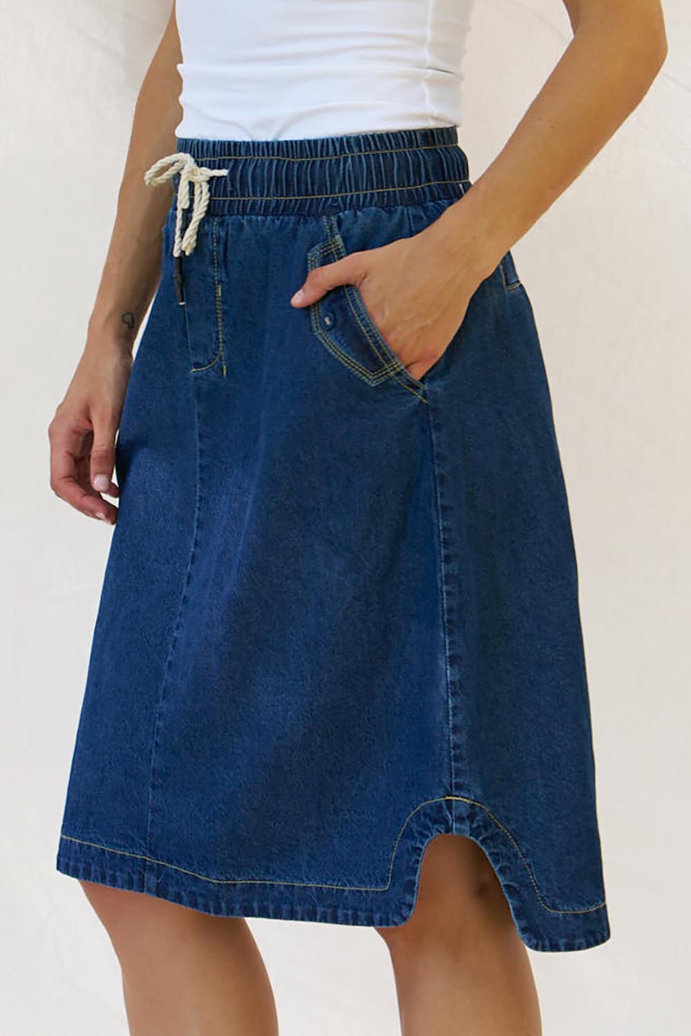 A model wearing the Desiree Cotton Denim Skirt in colour Bluewash (Blue), from the front, cropped image