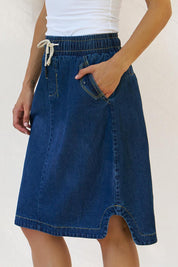 A model wearing the Desiree Cotton Denim Skirt in colour Bluewash (Blue), from the front, cropped image