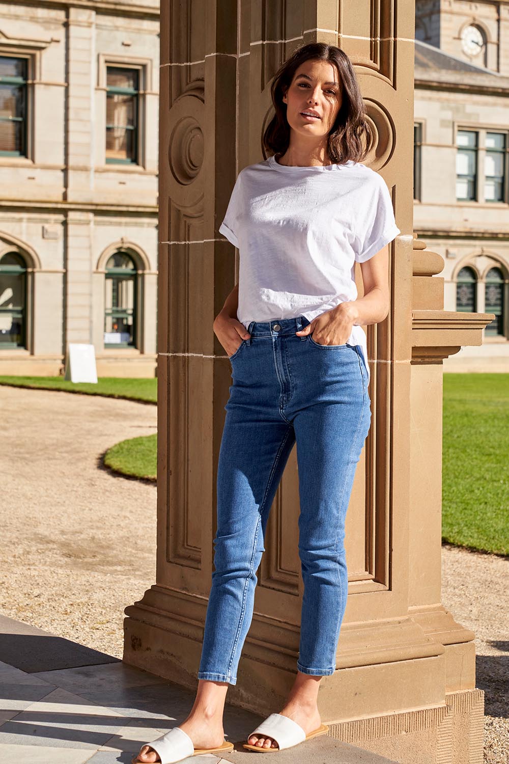 A model wearing the Betty Essential Jean in colour Vintage (Blue), from the front, showing the whole outfit