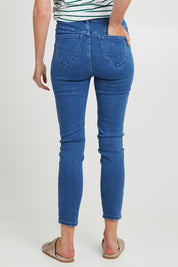 Model Madeline wearing size 10 of the Betty Essential Jean in colour Vintage (Blue), from the back