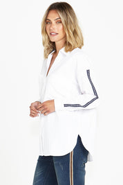 A model wearing the Delia Star Pocket Shirt in colour Whitestars (White), from the front, cropped image