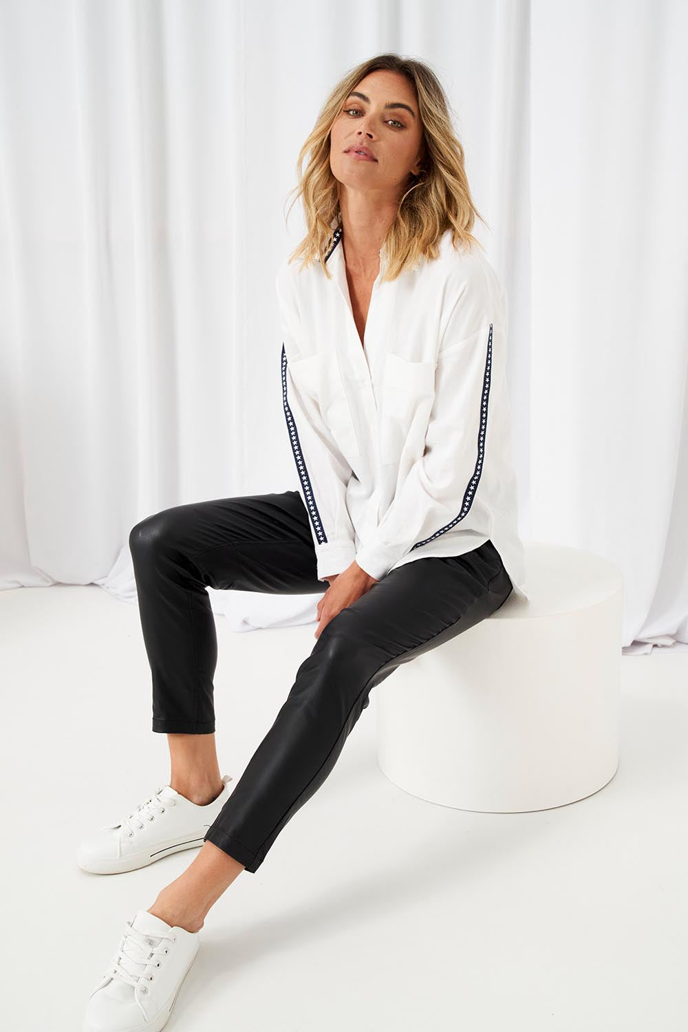 A model wearing the Delia Star Pocket Shirt in colour Whitestars (White), from the front, showing the whole outfit