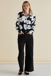 A model wearing the Wilma Wide Leg Jean in colour Black (Black), from the front, showing the whole outfit