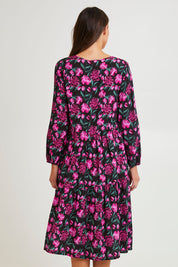 Model Madeline wearing size 10 of the Tenley Tiered Dress in colour Floral (Pink), from the back
