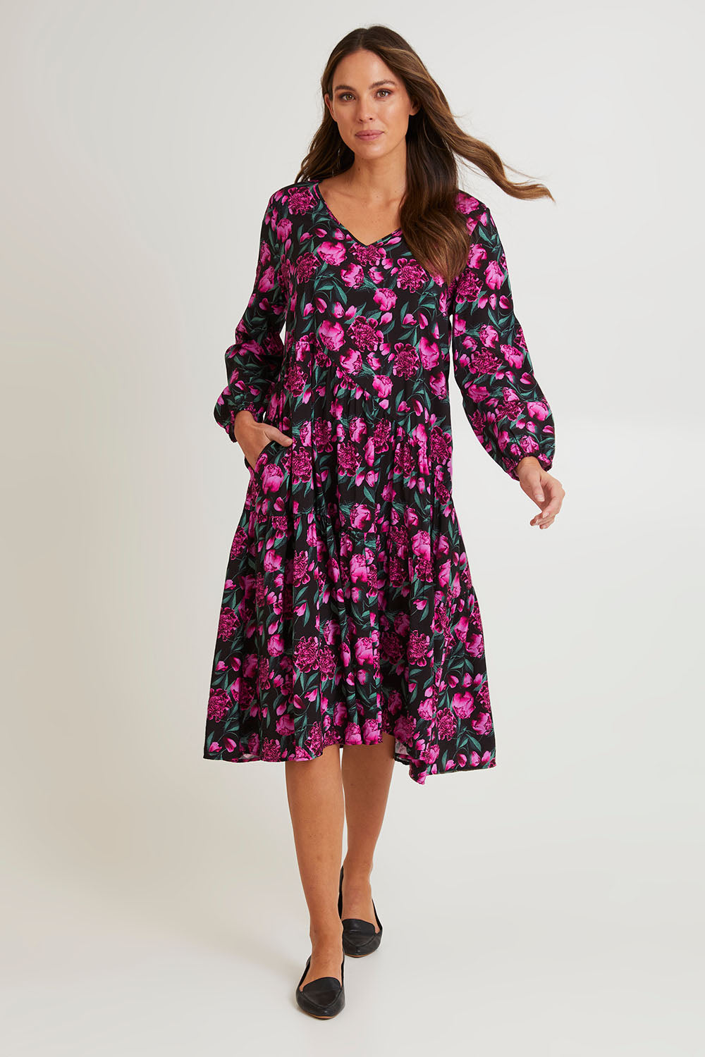Model Madeline wearing size 10 of the Tenley Tiered Dress in colour Floral (Pink), from the front, showing the whole outfit