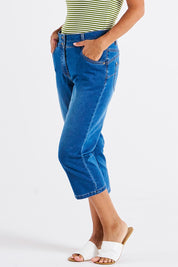 A model wearing the Alessi Crop Jean in colour Trueblue (Blue), from the front, cropped image