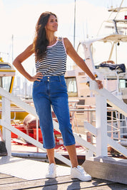 A model wearing the Alessi Crop Jean in colour Trueblue (Blue), from the front, showing the whole outfit