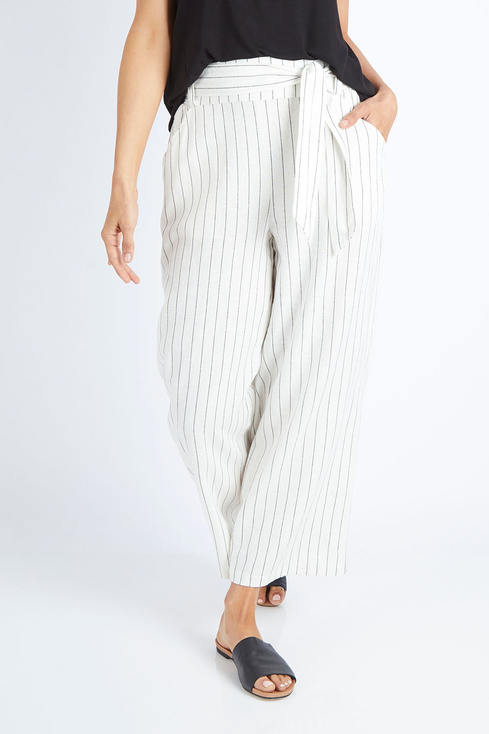 Model Gemma wearing size 10 of the Keto Pant in colour Pinstripe (White), from the front, cropped image