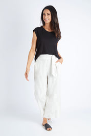 Model Gemma wearing size 10 of the Keto Pant in colour Pinstripe (White), from the front, showing the whole outfit