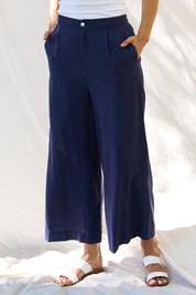 A model wearing the Aspen Linen Blend Palazzo Pant in colour Navy (Blue), from the front, cropped image