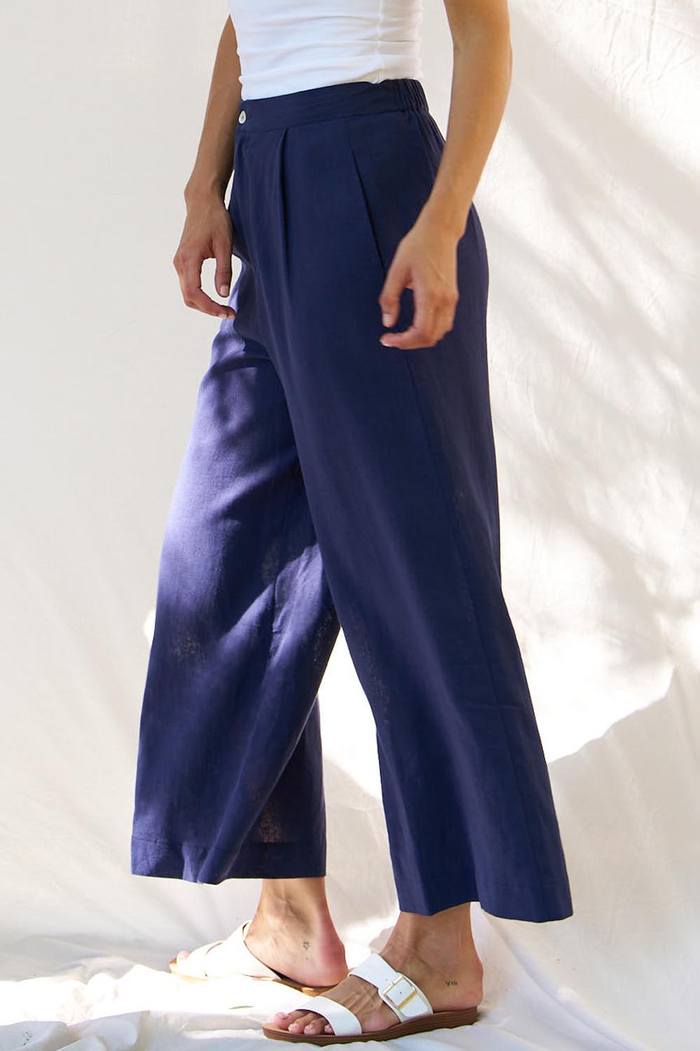 A model wearing the Aspen Linen Blend Palazzo Pant in colour Navy (Blue), from the front, cropped image