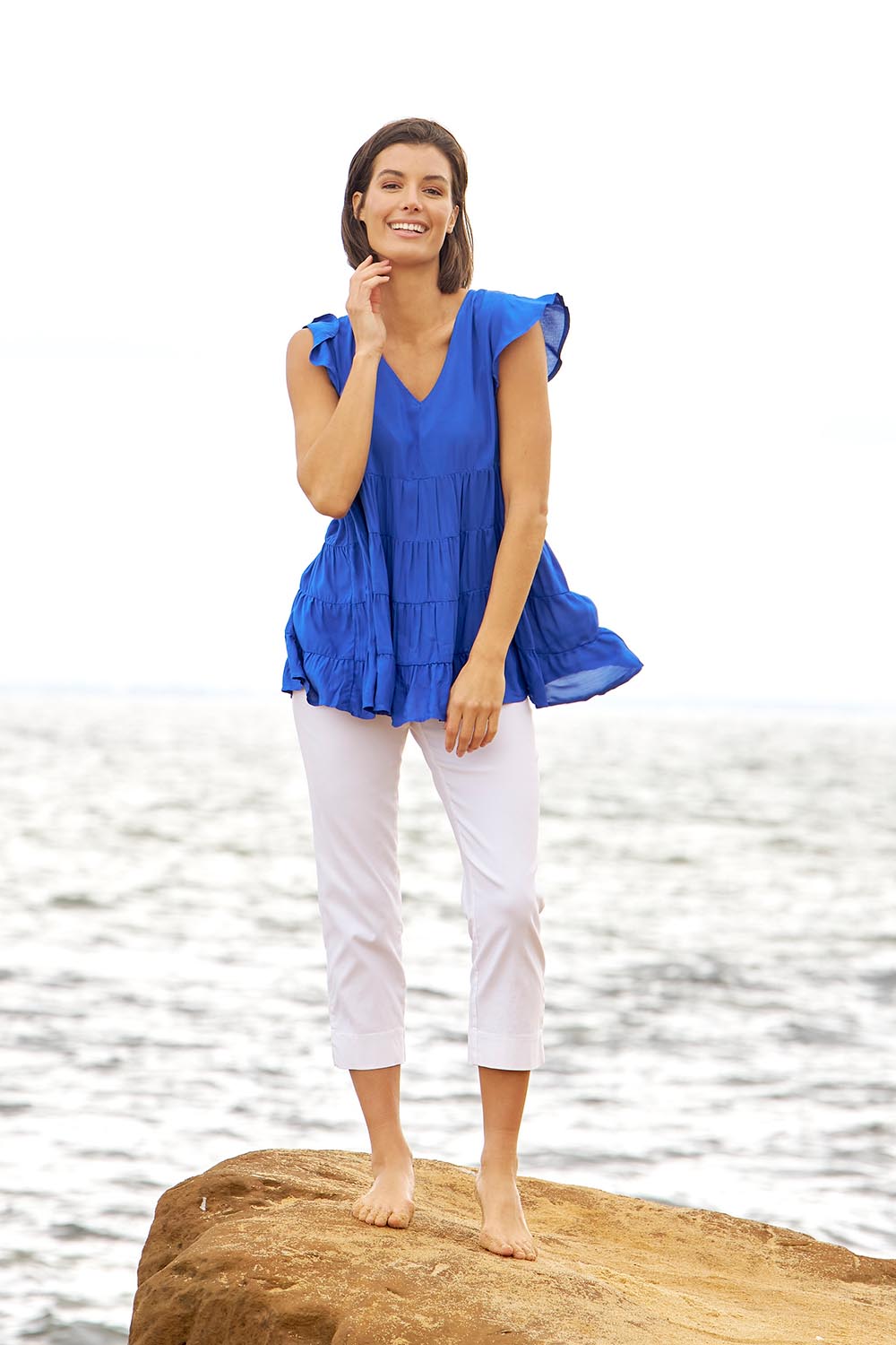 A model wearing the Danica Frill Top in colour Cobalt (Blue), from the front, showing the whole outfit