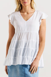 A model wearing the Danica Frill Top in colour White (White), from the front, cropped image