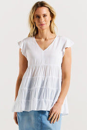 A model wearing the Danica Frill Top in colour White (White), from the front, cropped image