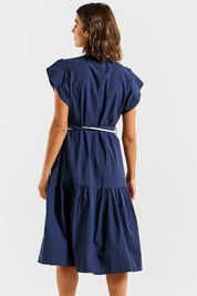 A model wearing the Mari Cotton Dress in colour Navywhite (Blue), from the back
