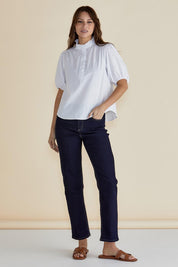 A model wearing the Avery Cotton Blouse in colour White (White), from the front, showing the whole outfit
