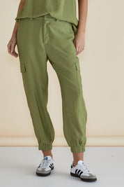 A model wearing the Adrianna Jogger in colour Pistachio (Green), from the front, cropped image