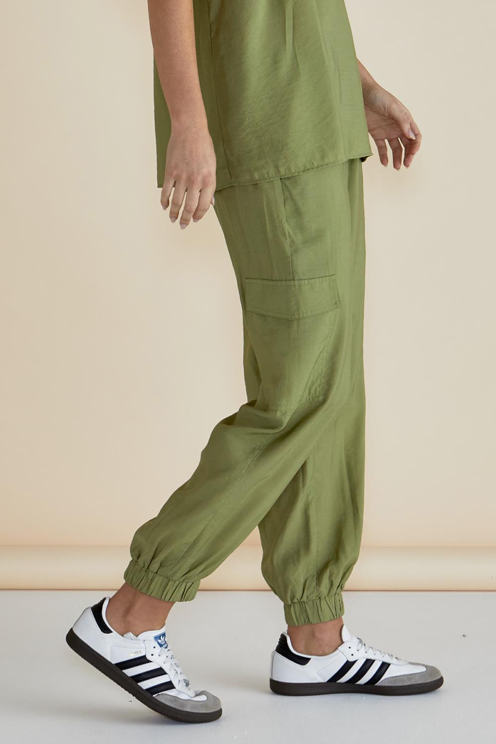 A model wearing the Adrianna Jogger in colour Pistachio (Green), from the front, cropped image
