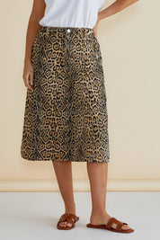 A model wearing the Astra Denim Skirt in colour Leopard, from the front, cropped image