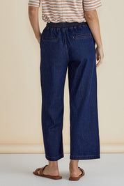 A model wearing the Drapey Denim Jogger in colour Sapphire (Blue), from the back