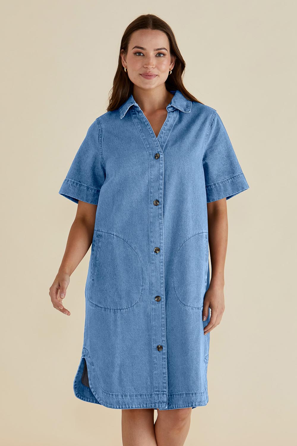 A model wearing the Dawson Denim Dress in colour Midwash (Blue), from the front, cropped image