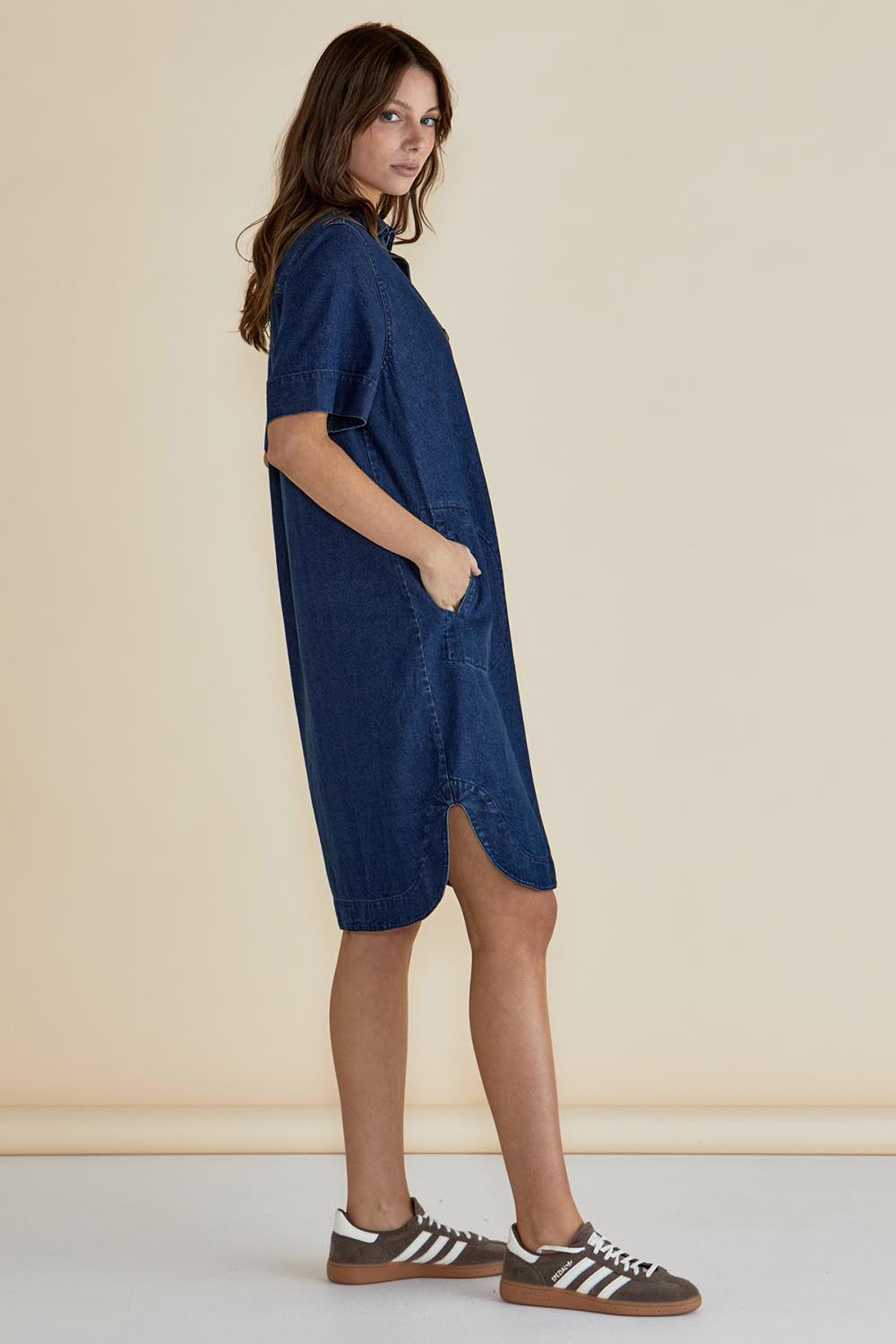 A model wearing the Dawson Denim Dress in colour Vintage (Blue), from the front, showing the whole outfit