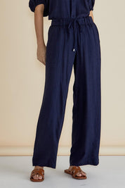 A model wearing the Tamara Pant in colour Darkblue (Blue), from the front, cropped image