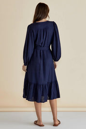A model wearing the Melissa Dress in colour Darkblue (Blue), from the back