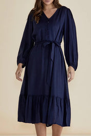 A model wearing the Melissa Dress in colour Darkblue (Blue), from the front, cropped image